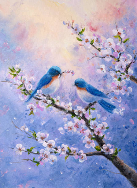 istock Charming bluebirds perched among blooming cherry blossoms in a vibrant spring sky 2202631050