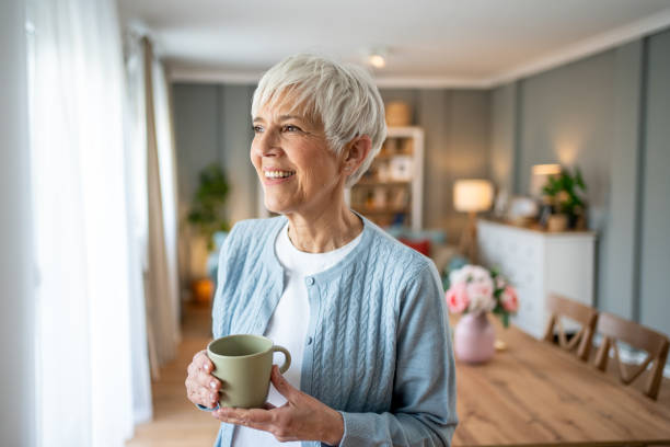 istock Short-haired older woman drinking her morning coffee 2202636530