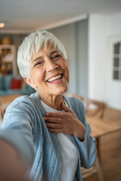 istock Content senior woman capturing a selfie in her home 2202636709
