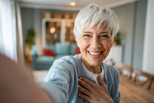 istock Content senior woman capturing a selfie in her home 2202636735