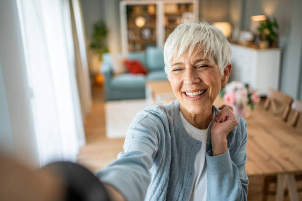 istock Content senior woman capturing a selfie in her home 2202636746