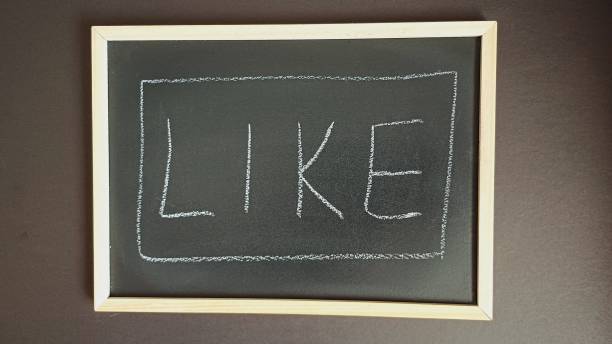 istock Blackboard background. The word LIKE is handwritten with chalk 2202636991