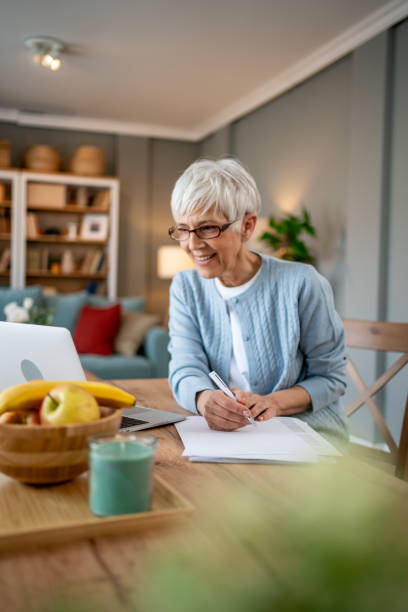 istock Mature woman using a laptop to work from home 2202637518