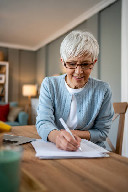 istock Mature woman using a laptop to work from home 2202637521