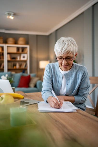 istock Mature woman using a laptop to work from home 2202637523