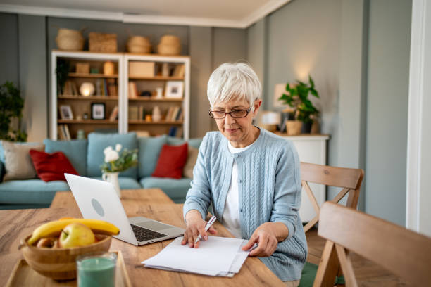 istock Mature woman using a laptop to work from home 2202637579