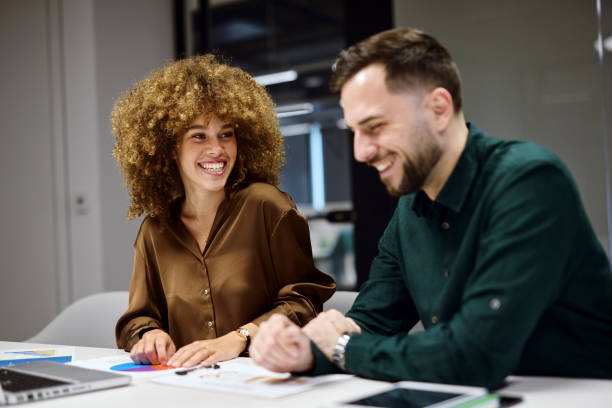 istock Young businesspeople laughing while working together in modern office 2202637892