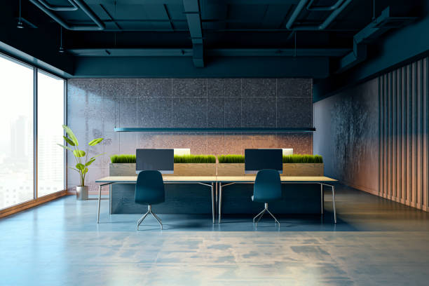 istock Modern office interior with dark loft design, featuring large windows with city view, wooden desks with computers, and green plants. 3D Rendering 2202639573