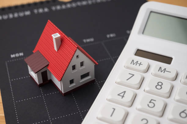 istock House model, calendar and white calculator. 2202641732
