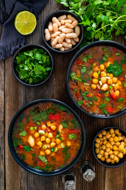 istock Fresh vegetable soup with chick-pea served in white bowl on wooden table 2202641749
