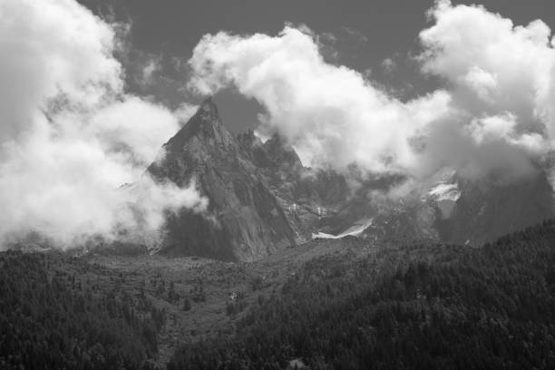 Beautiful mountain landscapes of the Alps on Tour du Montblanc hike. Green valley, snow summits and rocky peaks of Aiguilles de Chamonix and Montblanc. Summer sunny weather blue sky, trekking Alp hike