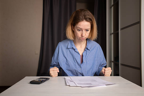 istock Angry Woman Reviewing Utility Bills and Financial Documents 2202649970