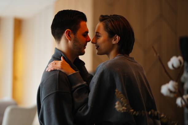 istock Couple embraces tenderly in a cozy indoor setting during evening 2202653821