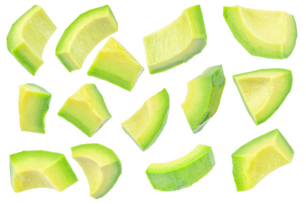 istock Avocado slices, peeled avocado cubes isolated on white background 2202654529