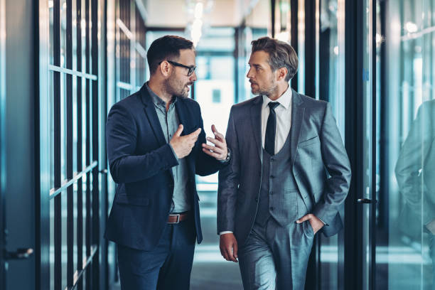 Company managers having a discussion in the corridor