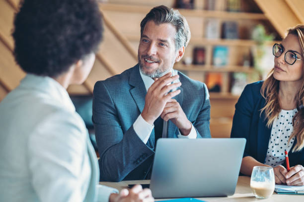 istock Focus on a middle age businessman during a meeting 2202655454