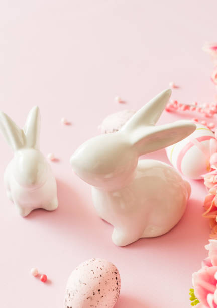 istock Easter bunnies and eggs on a pink background 2202657677