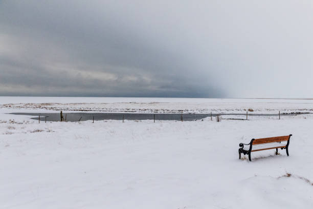 A winter scene in iceland, showing a snow-covered landscape on a somewhat cloudy day.