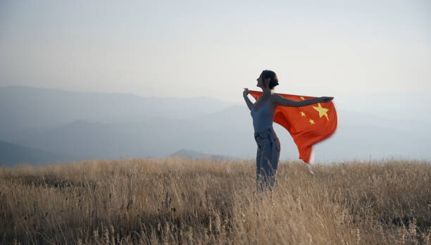 Cheering woman under Chinese flag