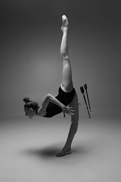 a studio shoot with multiple exposure black and white image with gymnastic posing