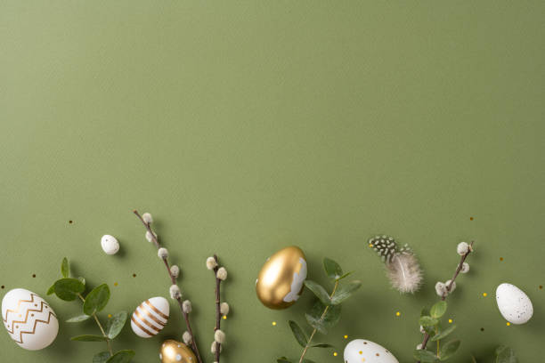 istock An arrangement of decorative Easter eggs, greenery, and natural elements placed on a green surface 2202668692