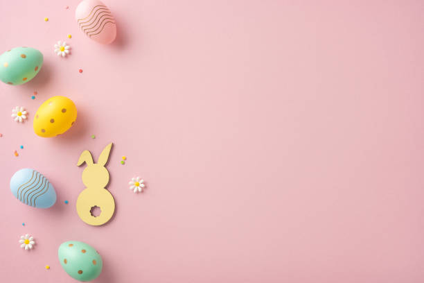 istock Easter celebration theme displayed with pastel eggs, bunny cutout, and daisies on pink 2202668714