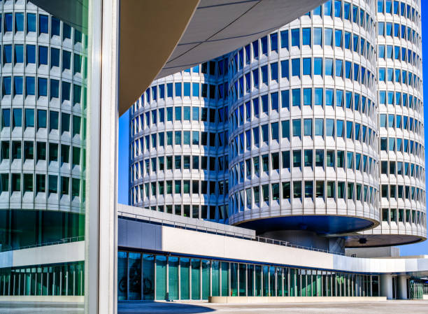 Modern building facade with cloudy sky reflecting in windows