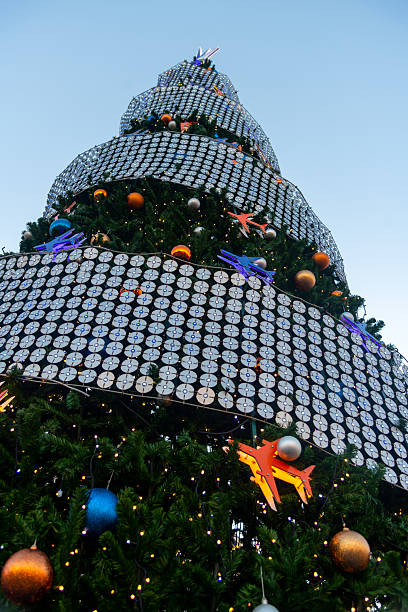 istock Holiday decorations shine on a towering Christmas tree in an urban setting 2202670383