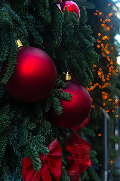 istock Decorative red ornaments and green pine branches during holiday season 2202670570