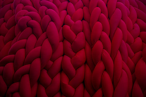 istock Bold red textured fabric showcasing intricate braided patterns and depth 2202670729