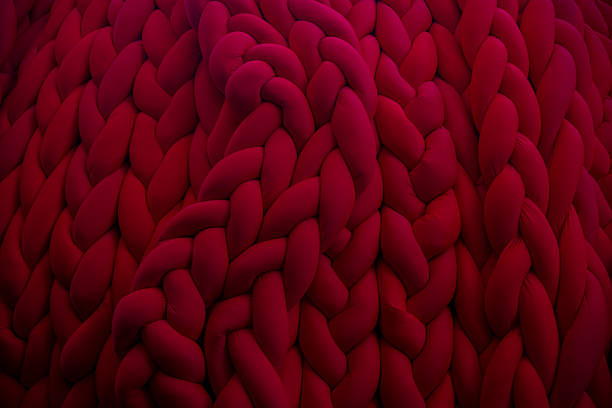 istock Vibrant red knitted texture creates an inviting cozy atmosphere 2202670732