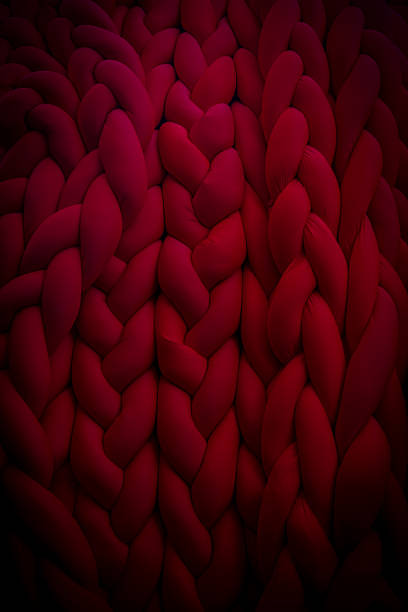 istock Textured red knit fabric showcasing intricate patterns in soft fibers 2202670733