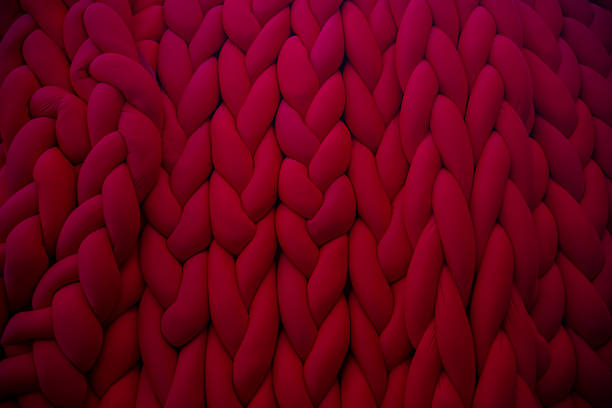 istock Detailed close-up of red knitted texture showcasing vibrant patterns 2202671371