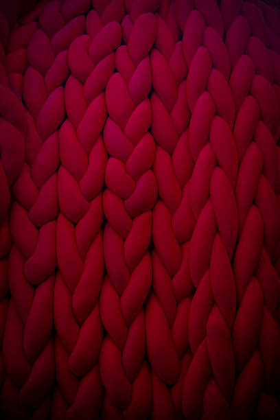 Knitted fabric with intricate patterns in bold red hues displayed prominently