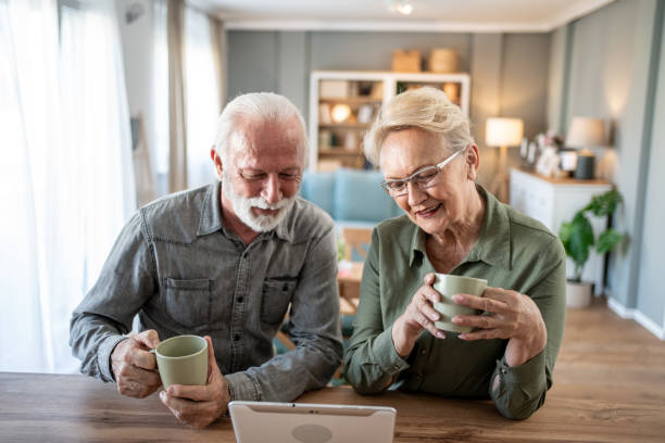 istock Older couple spending time together with coffee and tablet 2202671875
