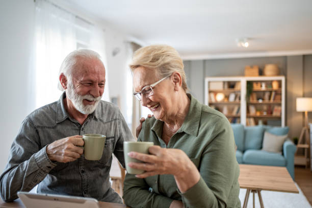 istock Older couple spending time together with coffee and tablet 2202671876