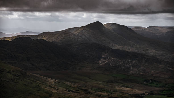 istock The rugged landscape features steep mountains and deep valleys, surrounded by ominous clouds that hint at changing weather. The view captures the essence of nature's raw beauty. 2202674049