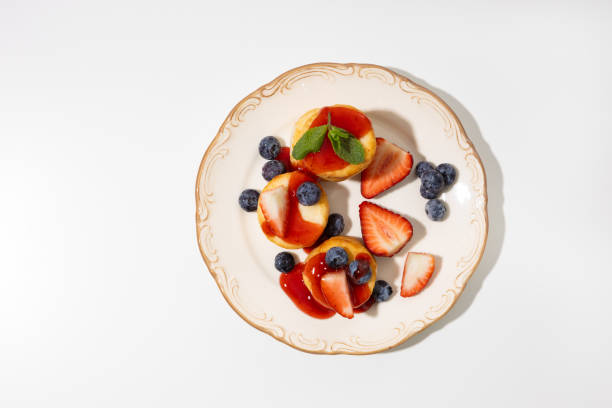 istock Top view of cottage cheese with berries on plate breakfast dish 2202674147
