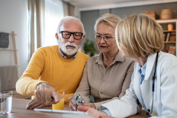 istock Doctor explaining medication to a senior couple 2202674304