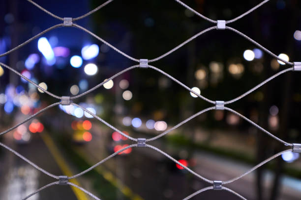 A view of Gloucester Road, Wan Chai from behind a wire fence of a footbridge.