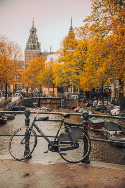 istock Bicycle on a Bridge Over an Amsterdam Canal in Autumn, Netherlands 2202677887