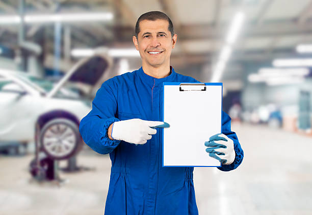istock Mechanic showing his clipboard at the workshop 2202678508