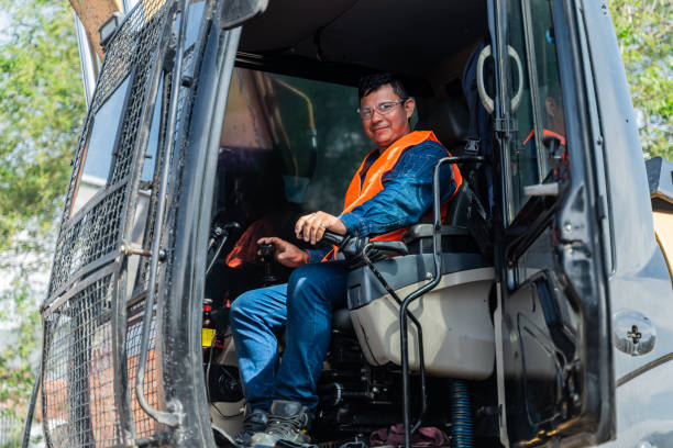 istock Portrait of a construction worker operating with backhoe at a construction site 2202680433