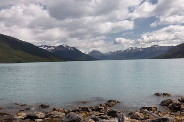 Landscape of Lago Argentino with mountains, dramatic sky and icy water