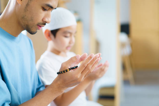 istock Asian muslim man and son are praying for Allah. 2202685259