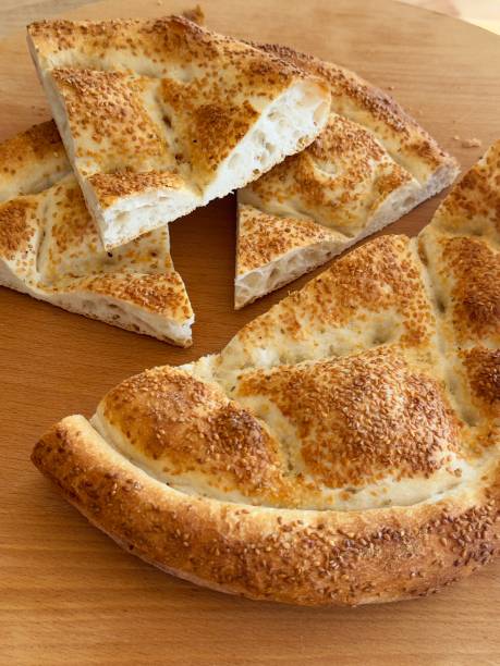 istock Ramadan pita (Ramazan Pidesi) bread on wooden table 2202691035