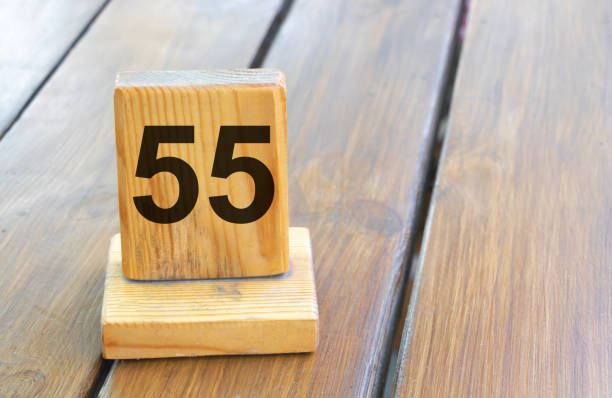 istock Wooden priority number 55 on a plank tab 2202692920