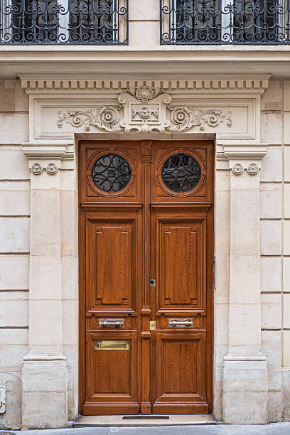 Detail of the exterior architecture of the door, window and balcony of an old building in Paris, France