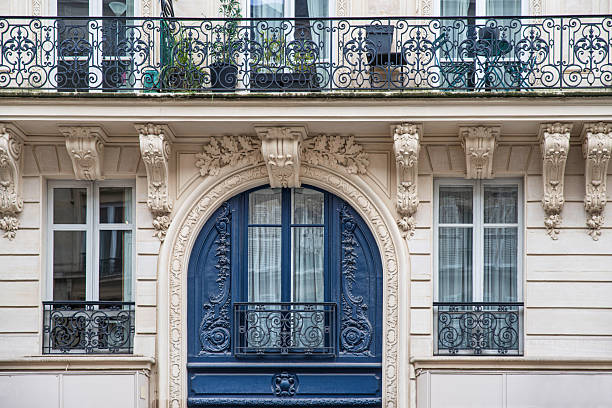 Detail of the exterior architecture of the window and balcony of an old building in Paris, France