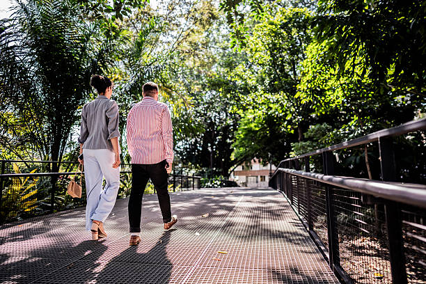 istock Coworkers walking in a public park 2202693871